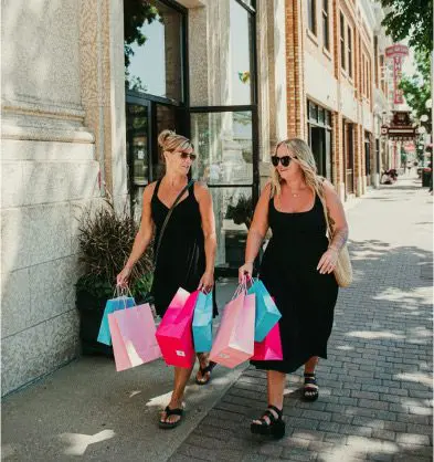 Lady waving from Notoriously Chic Store